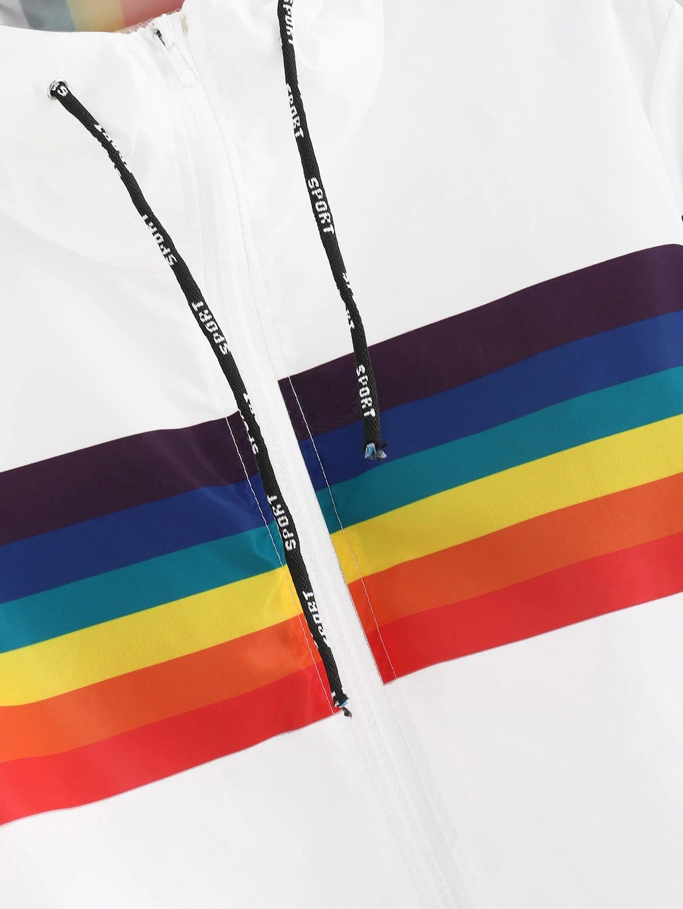 Close up of a White windbreaker with rainbow across the chest and sleeves
